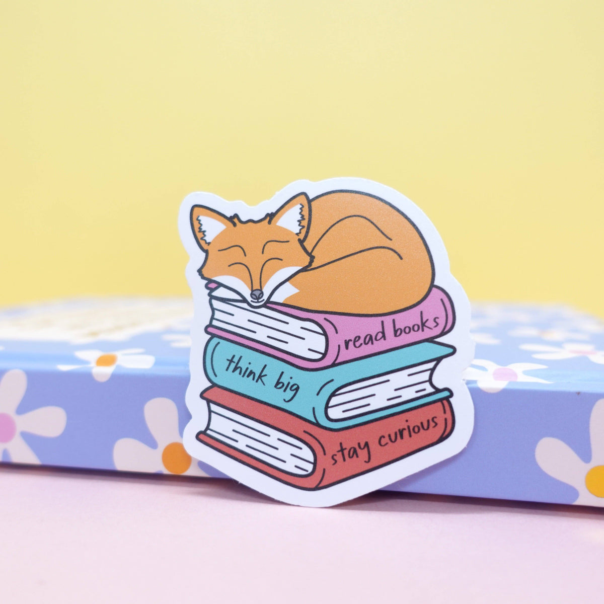 Maple the fox bookish sticker on a laptop cover