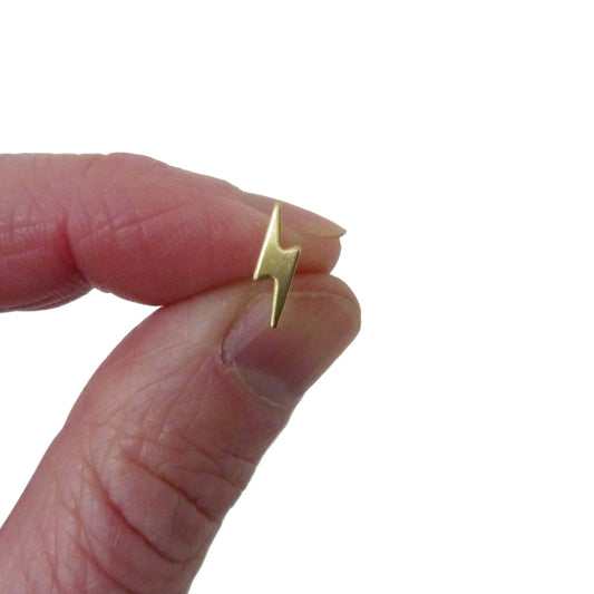 Close up of gold lightning bolt studs with sterling silver posts
