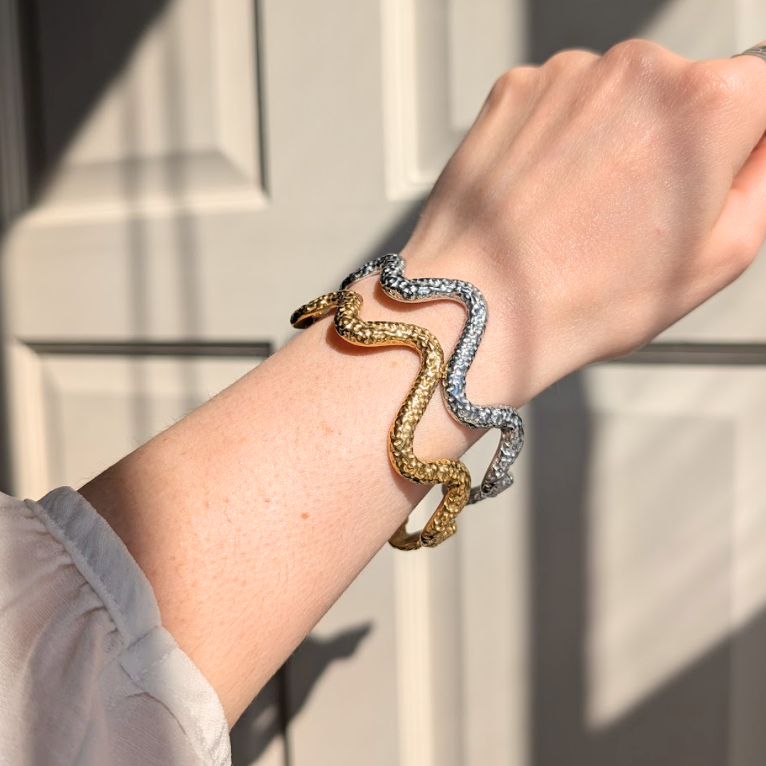 Model wearing stacked everyday gold dimple wave bangle