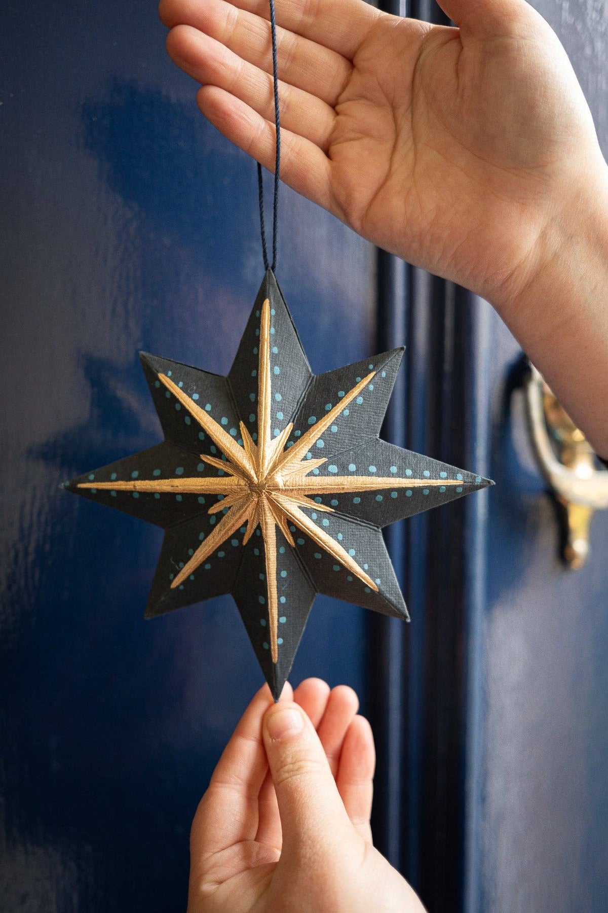 Handcrafted recycled board star decoration with cotton loop