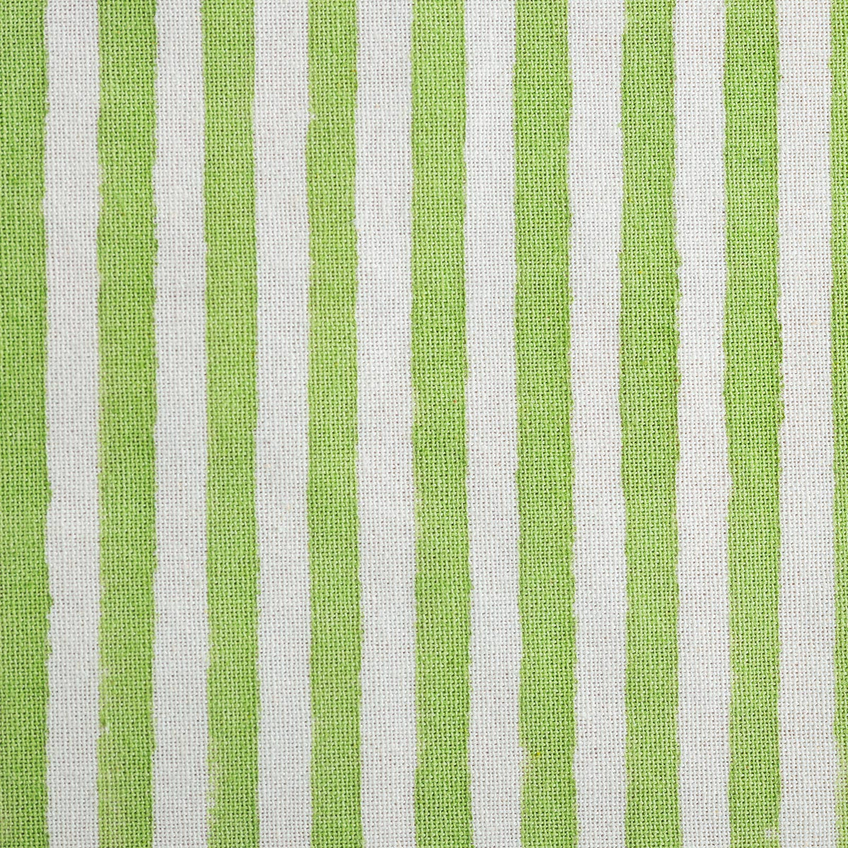 Close up of block printed green stripe pattern on cotton tea towel