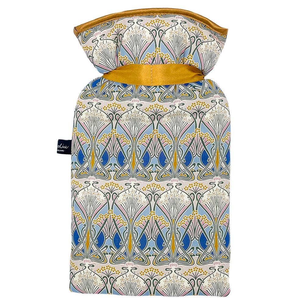 Liberty Ianthe Nouveau hot water bottle on a cosy blanket, ready for gifting.