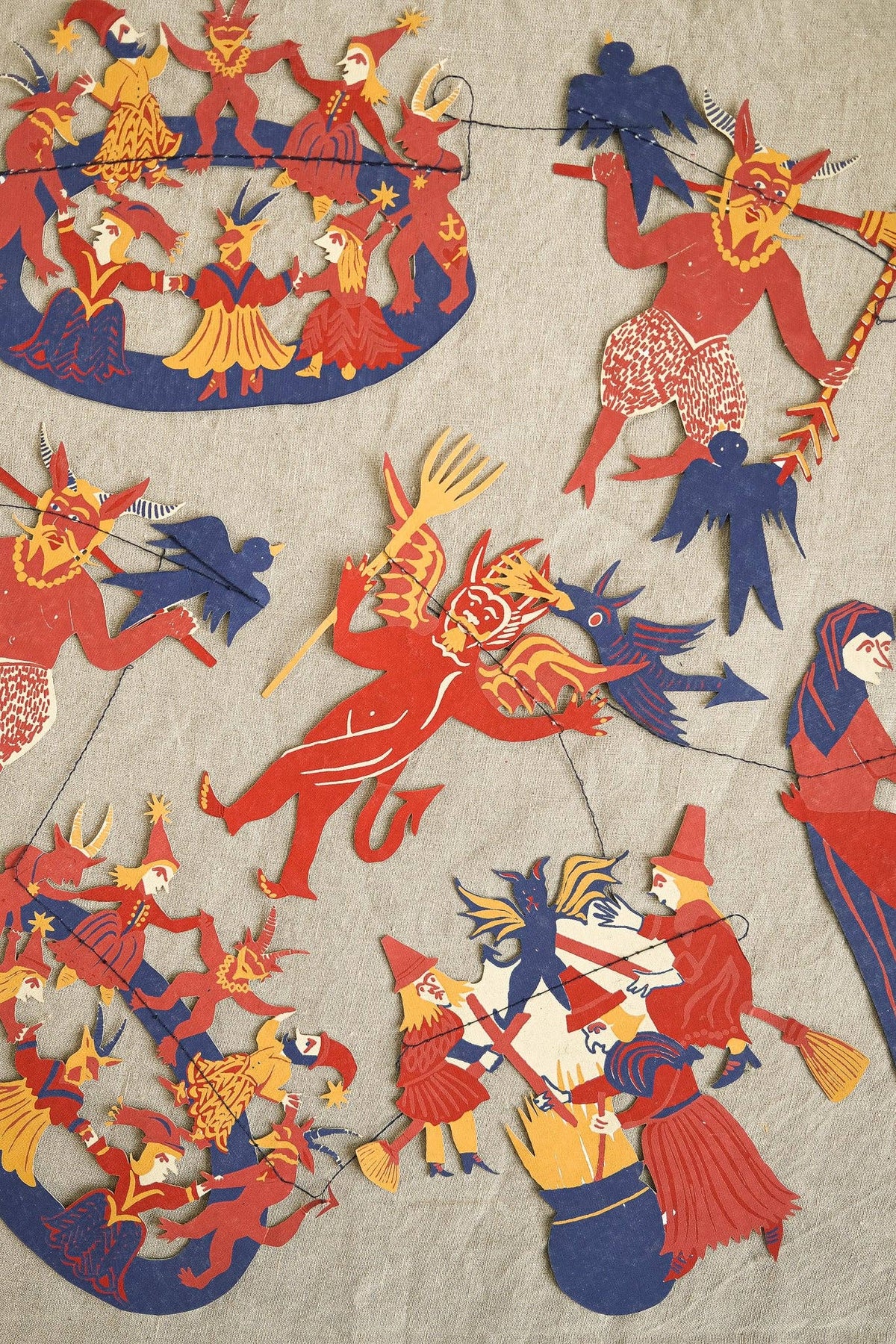 Close up of recycled paper shapes on cotton thread