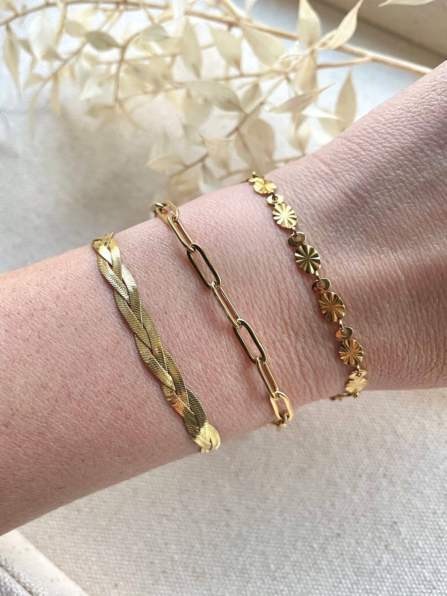 A plaited chain bracelet that sits flat to your wrist. Made of three entwined delicate snake chains. 18k gold plated bracelet. Light and comfortable enough to wear all day, and works well as a stacking piece for a more eye-catching look.