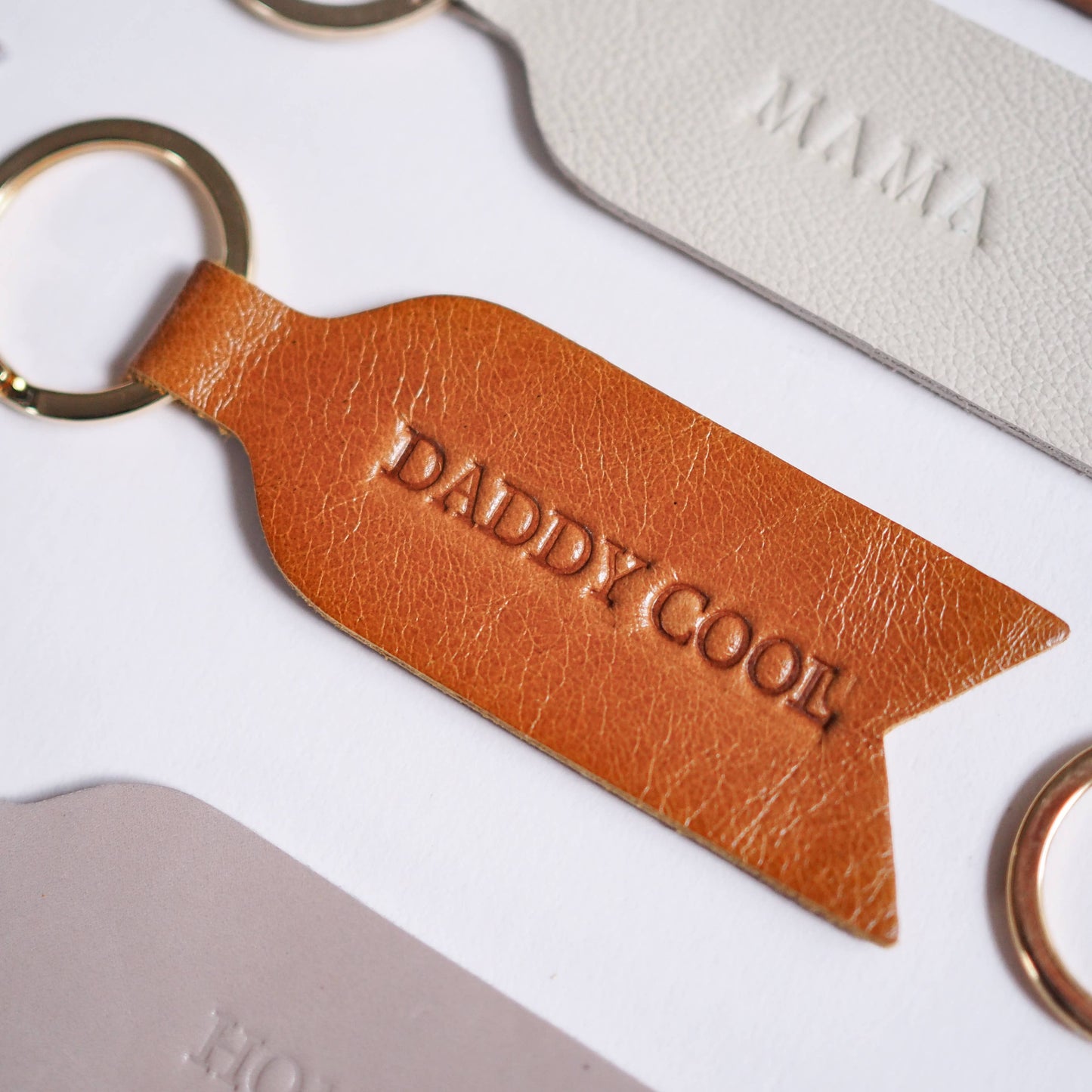 DADDY COOL leather keyring in tan. Soch and Co's handmade heat embossed leather keyrings make the perfect Father's Day present. Included on an A6 backing display.