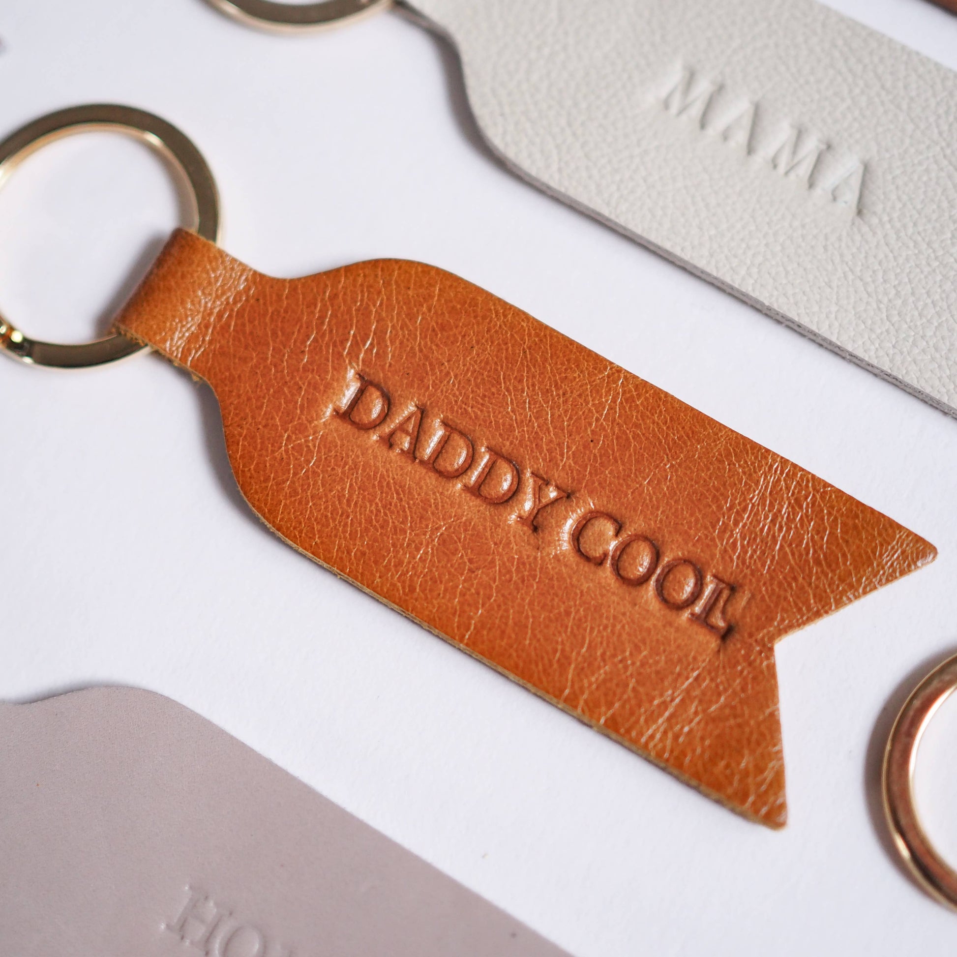 DADDY COOL leather keyring in tan. Soch and Co's handmade heat embossed leather keyrings make the perfect Father's Day present. Included on an A6 backing display.