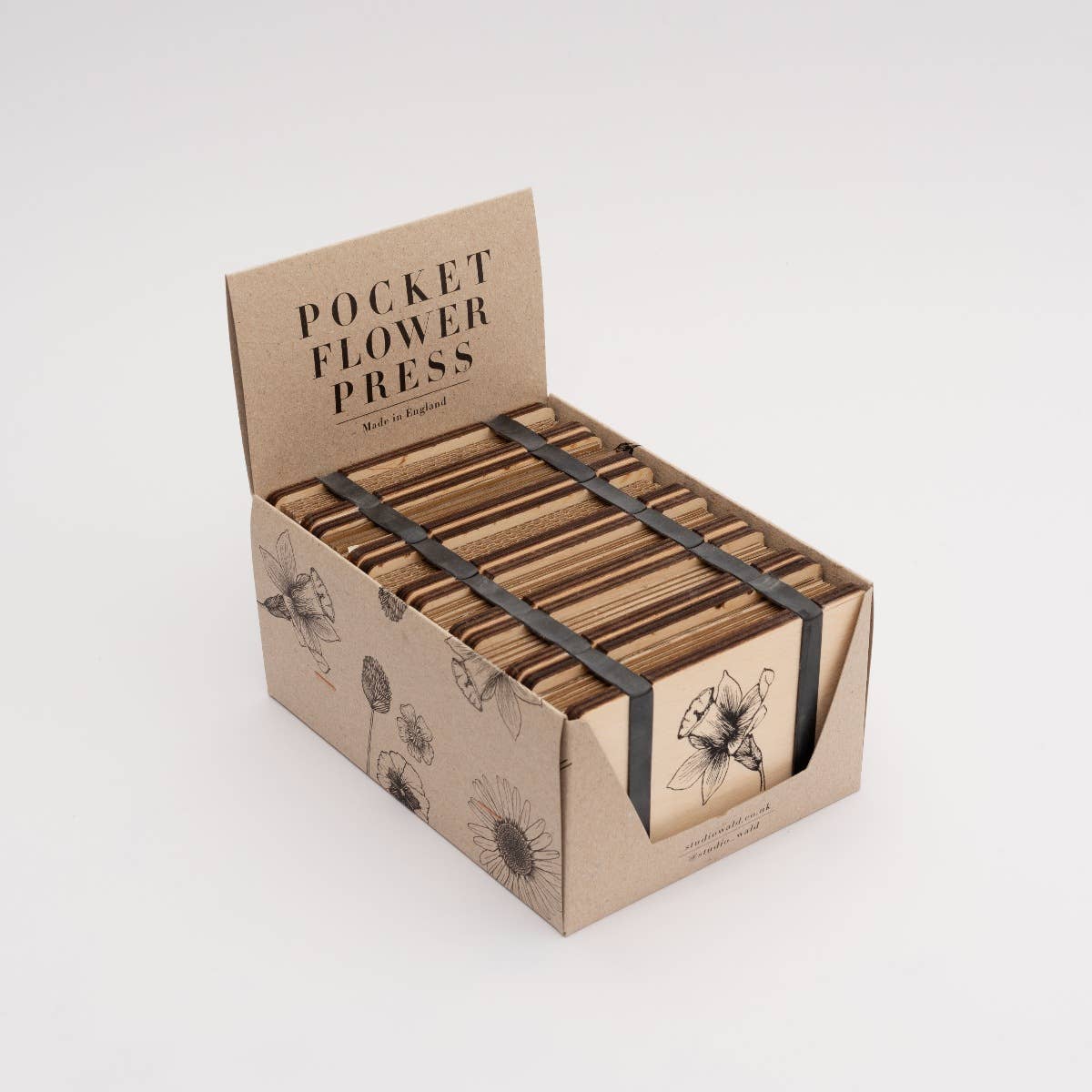 Pocket Flower Press made from sustainable maple veneered wood with corrugated card and sugar paper sheets, silicone rubber bands; pocket-sized and handmade in England.