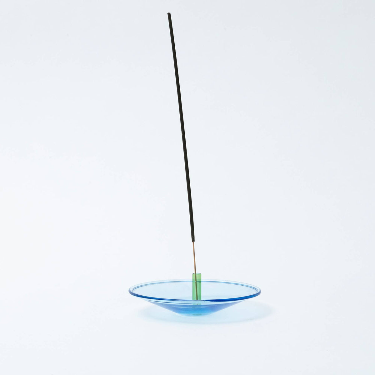 Handmade glass incense stick holder catching ash
