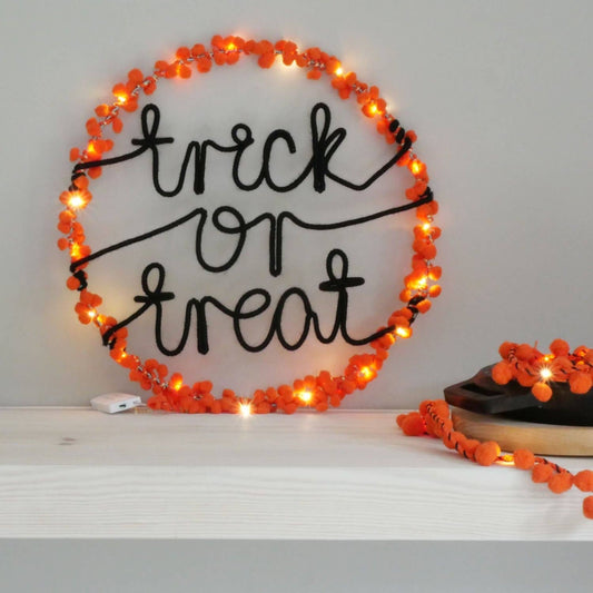 Trick or Treat Halloween hoop light hanging on a front door, festive decoration