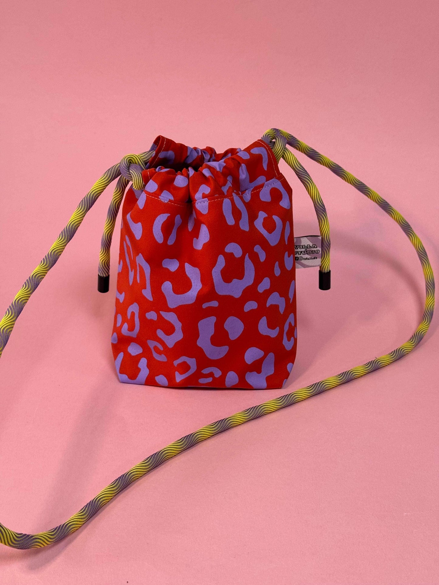 Close-up of the handprinted waxed cotton detail on the mini festival bag