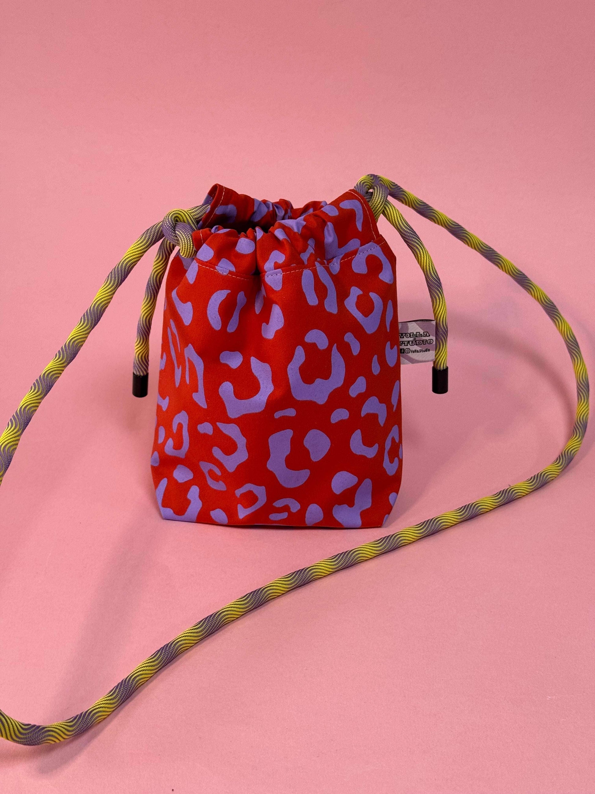 Close-up of the handprinted waxed cotton detail on the mini festival bag