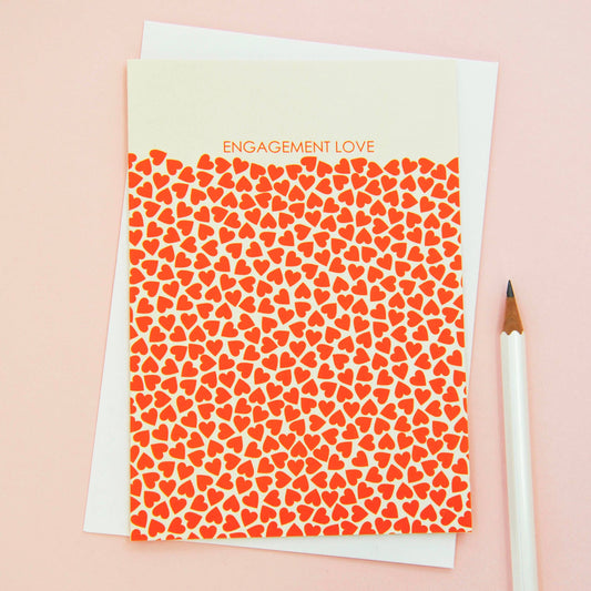 Happy Engagement card featuring tangerine red mini heart design, printed on sustainable 350gsm matt card with cream envelope, blank inside.