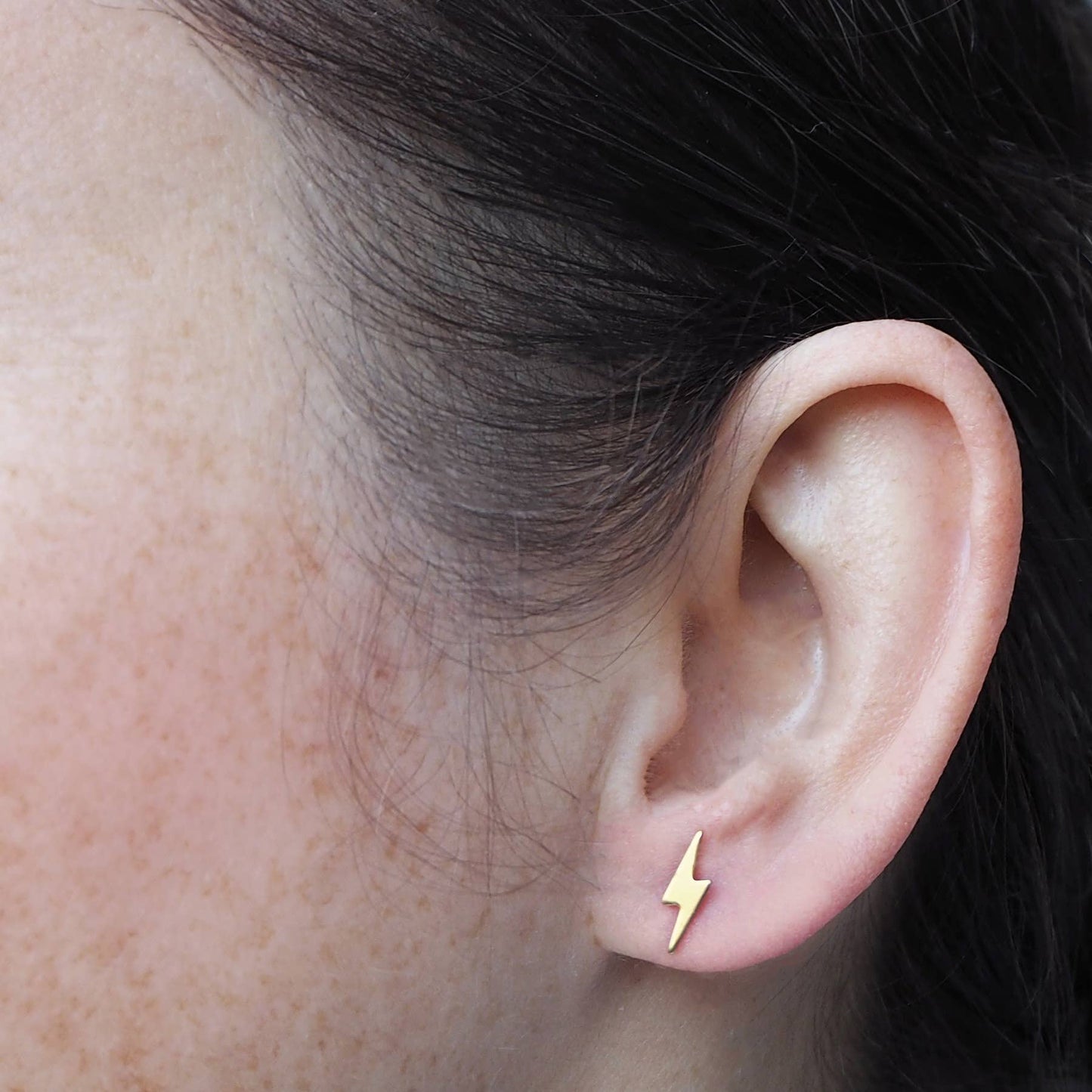 Tiny gold lightning bolt stud earrings for everyday wear