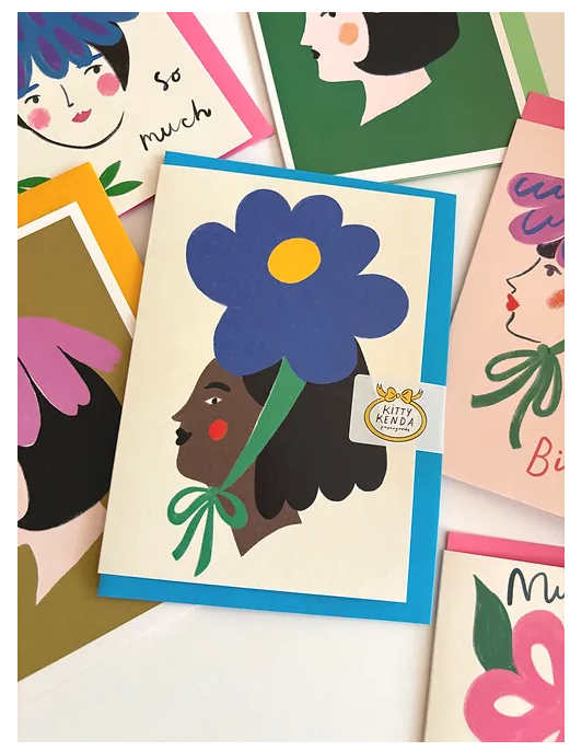 A stylish hand-illustrated design featuring a lady adorned with a magnificent blue bloom as her headpiece. Ideal for your flower-obsessed friends when you want to say "happy birthday" or "thanks a bunch!"