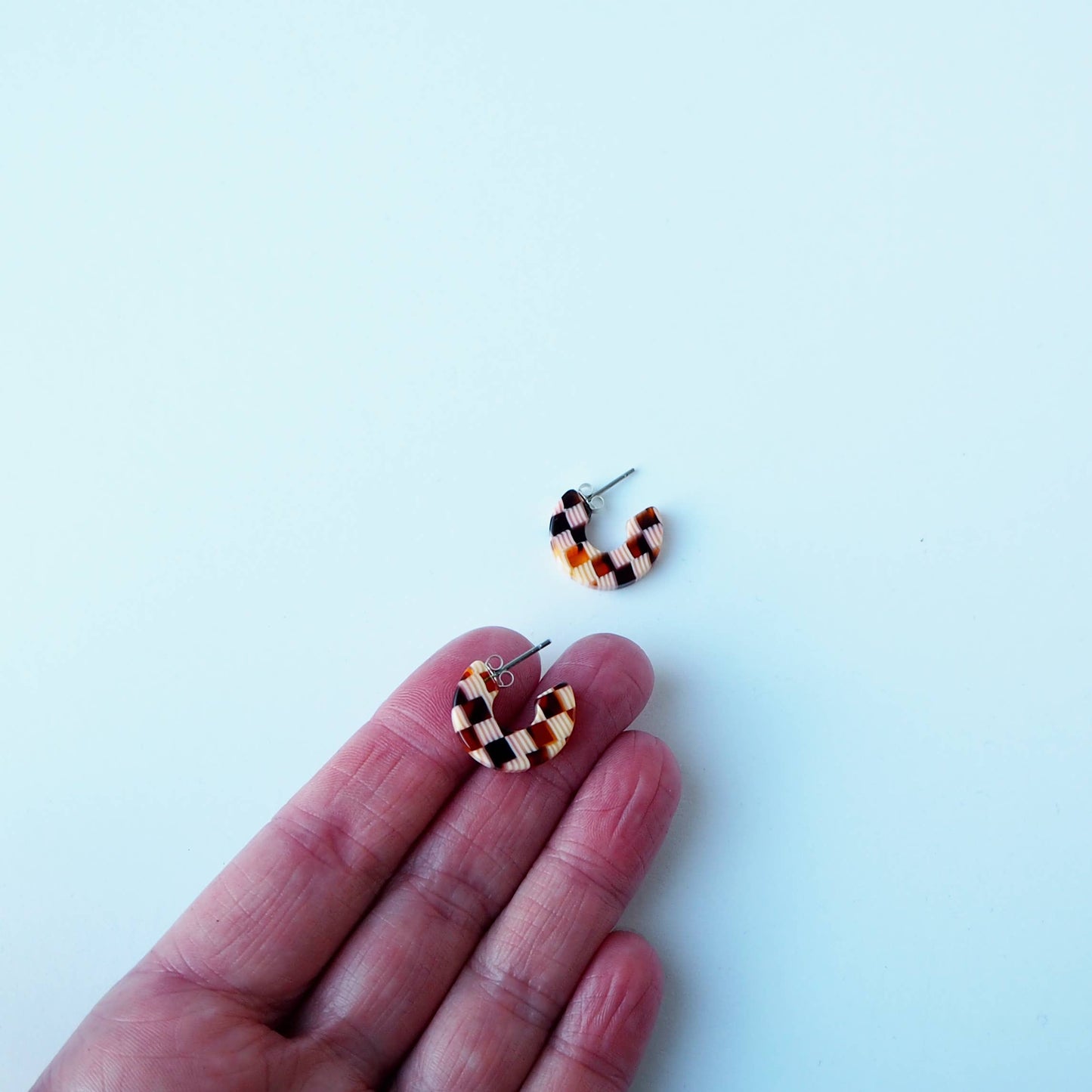 Close up of Honey Checker acetate pattern on hoop earrings