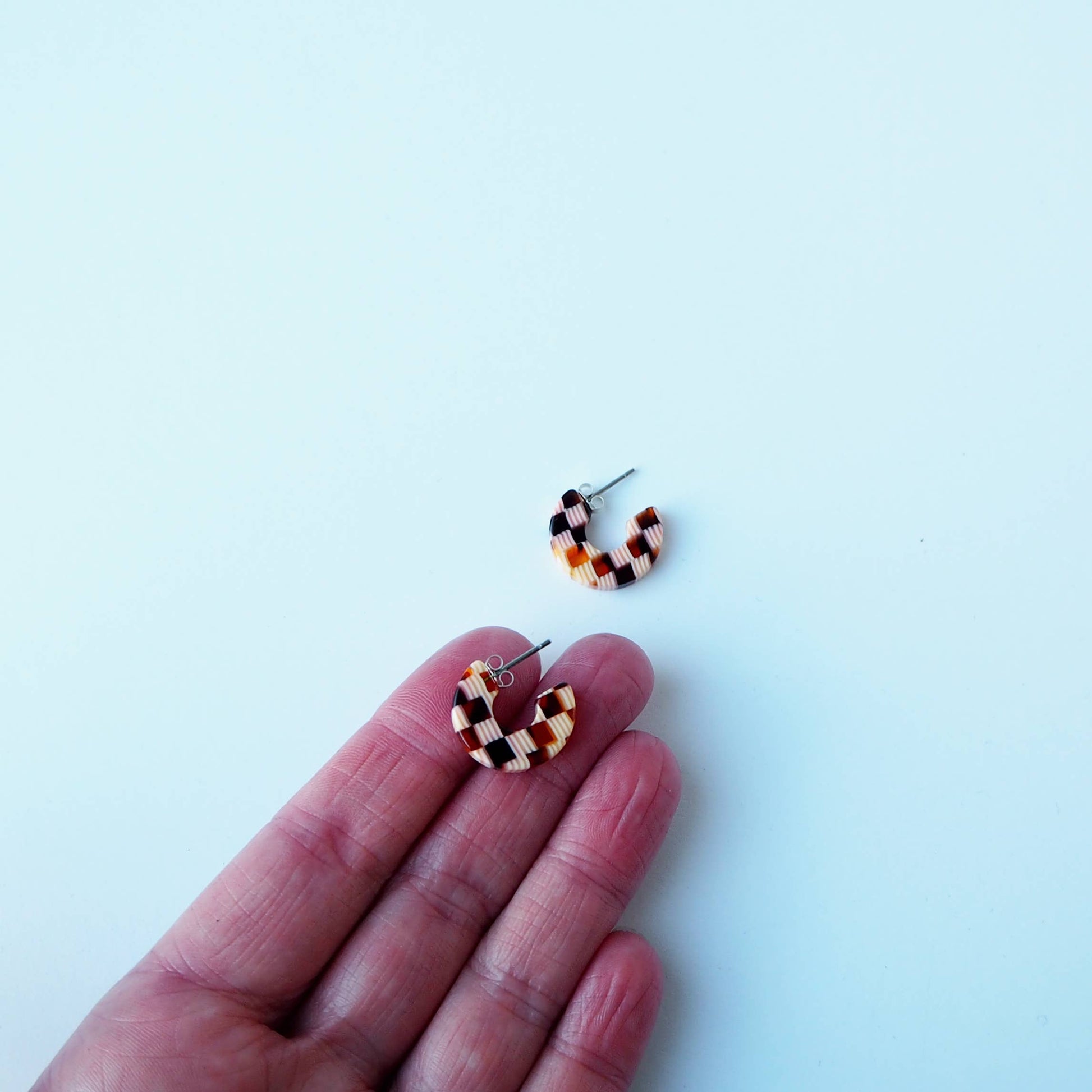 Close up of Honey Checker acetate pattern on hoop earrings