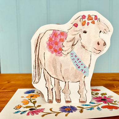 This fabulous birthday pony, wants to wish you a Happy Birthday. Complete with a beautifully illustrated envelope adorned with colourful birthday flowers. Original illustrated die cut design card.