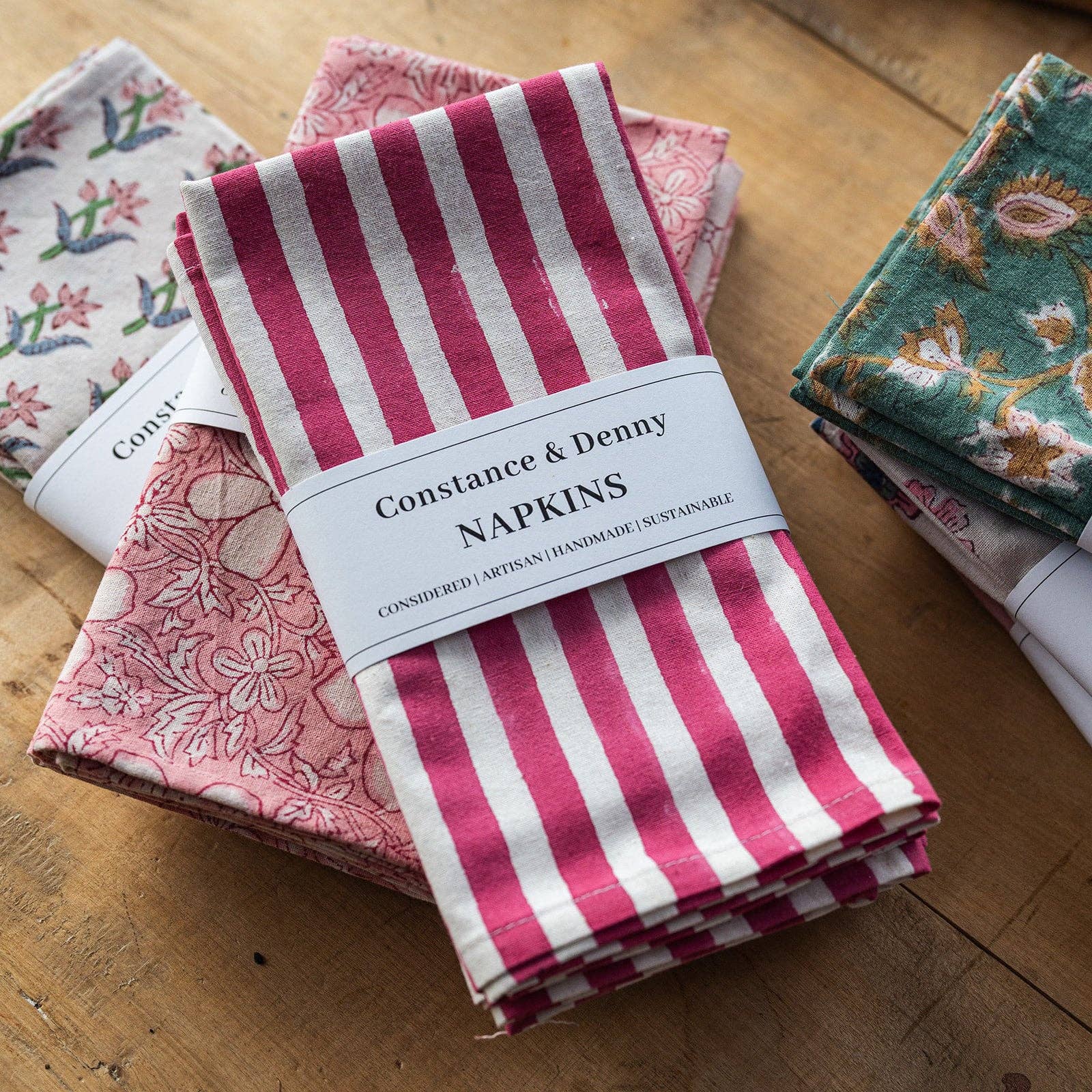 Artisan made pink stripe napkins folded on a table