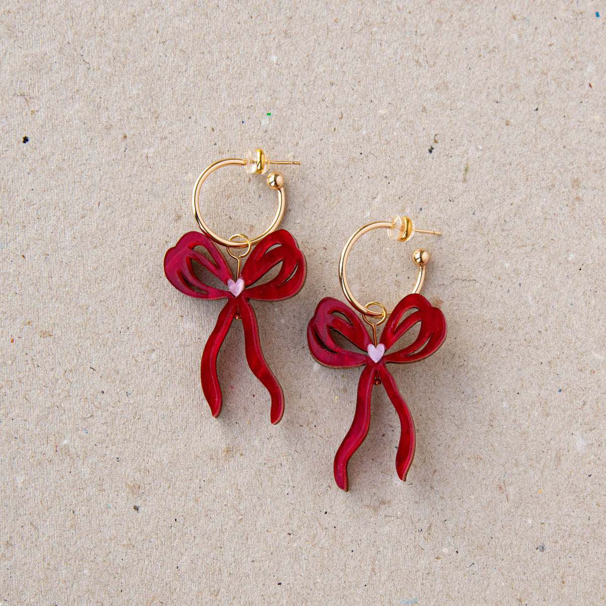 Lifestyle shot of woman wearing oversized bow hoop earrings