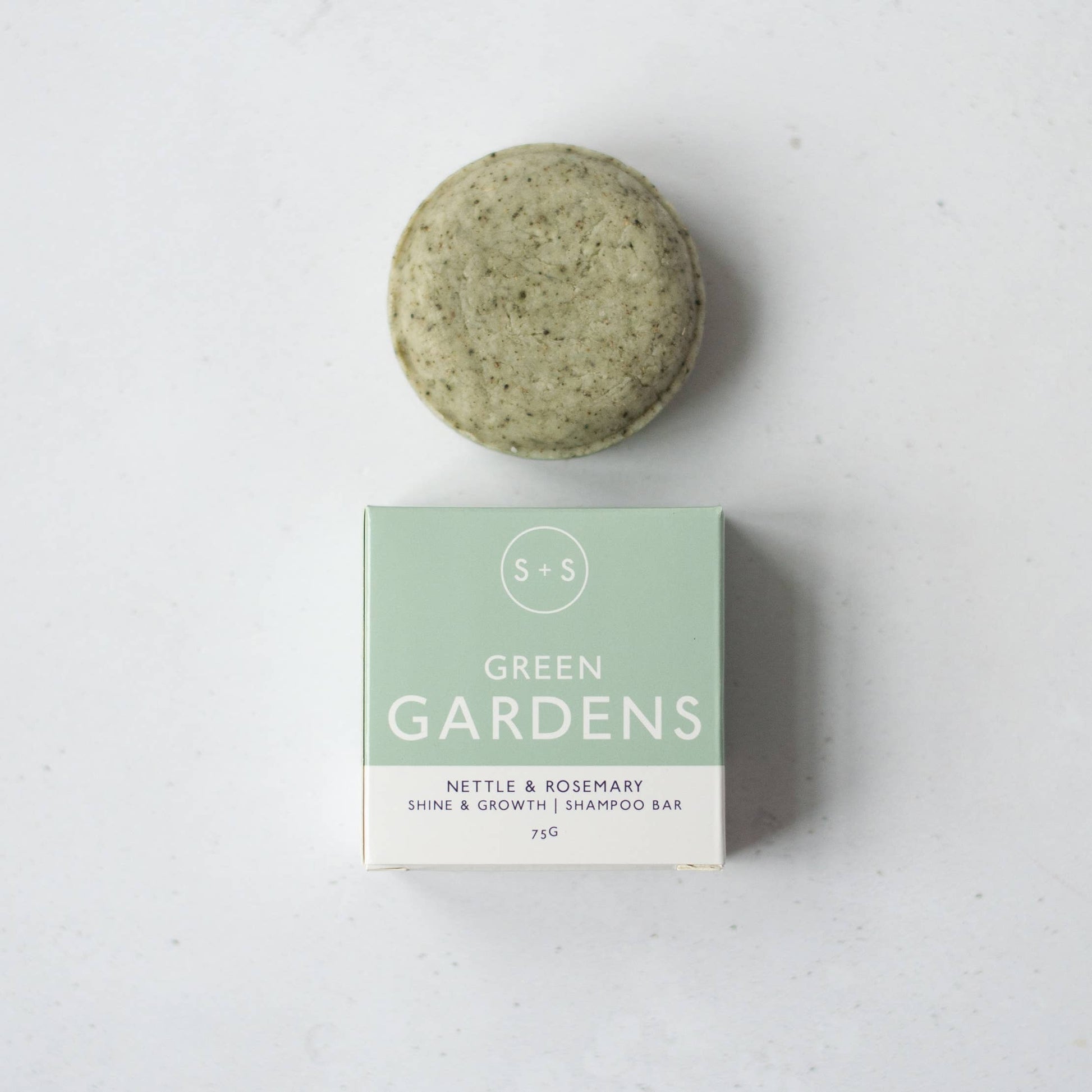 Green Gardens nettle and rosemary shampoo bar with eco-friendly packaging.