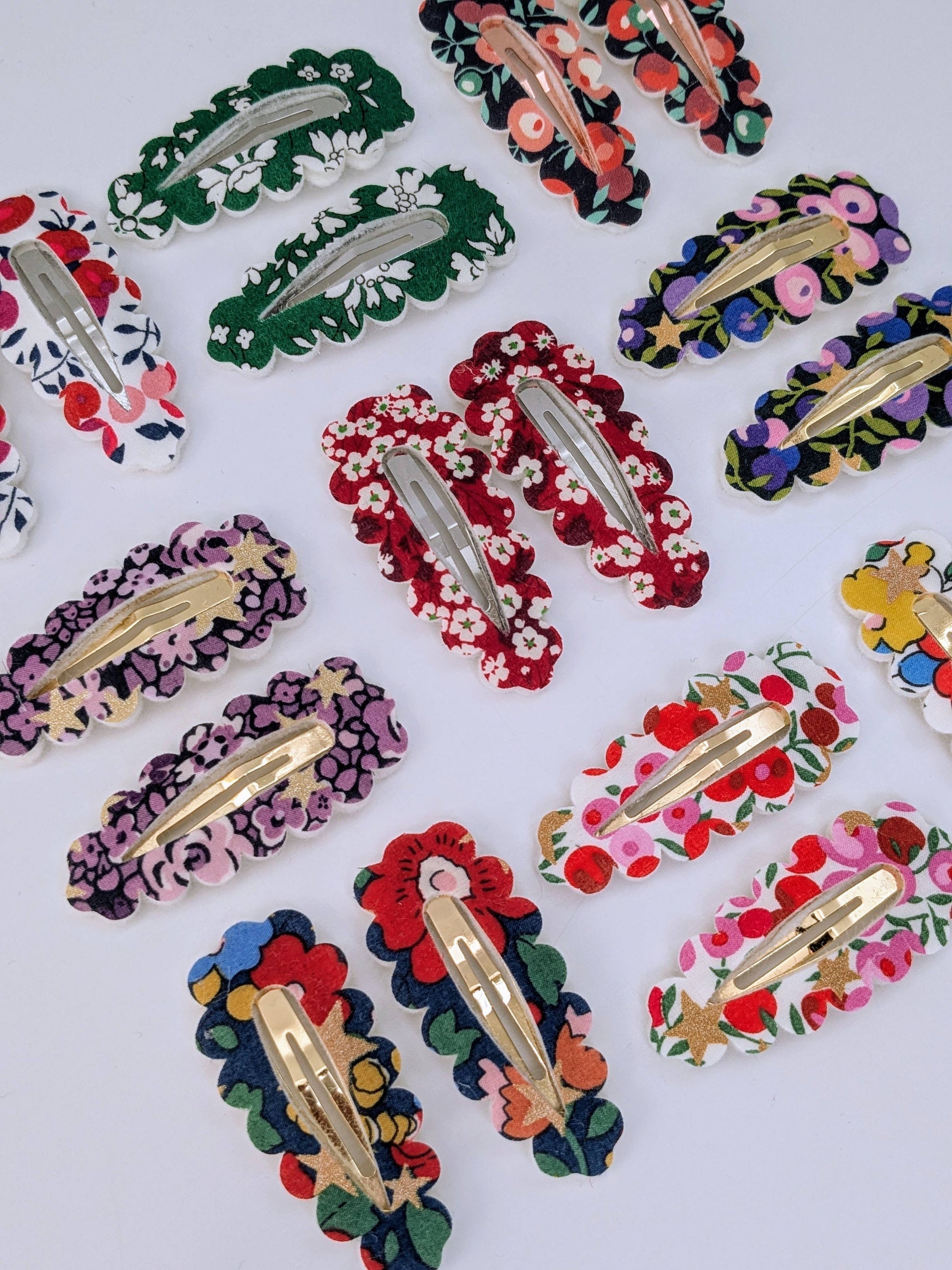 Colorful floral hair clips on a white background