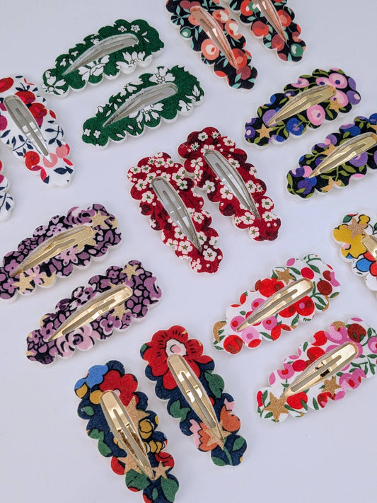 Colorful floral hair clips on a white background