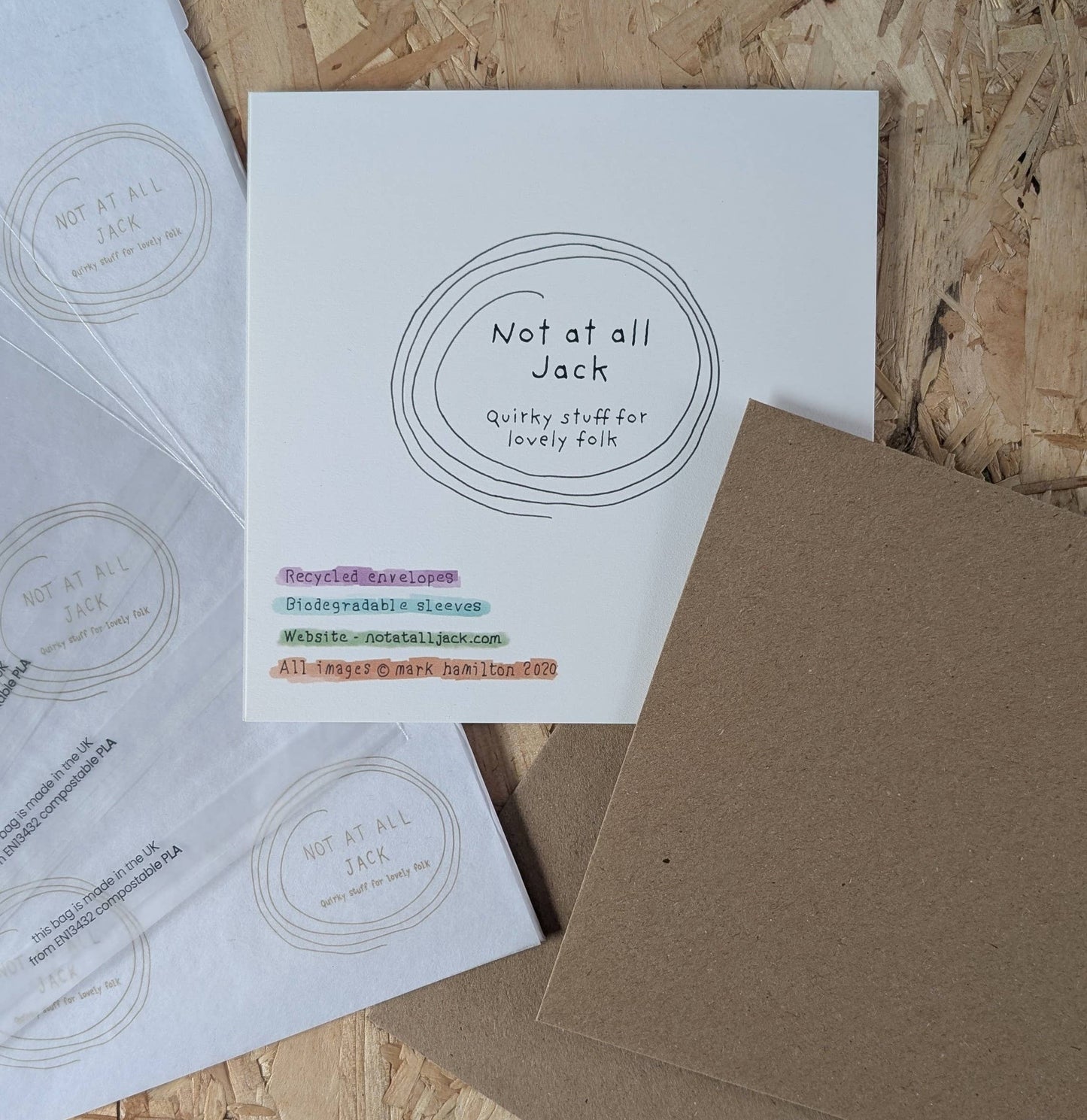 Stationery items with 'Not at all Jack' branding on a wooden surface