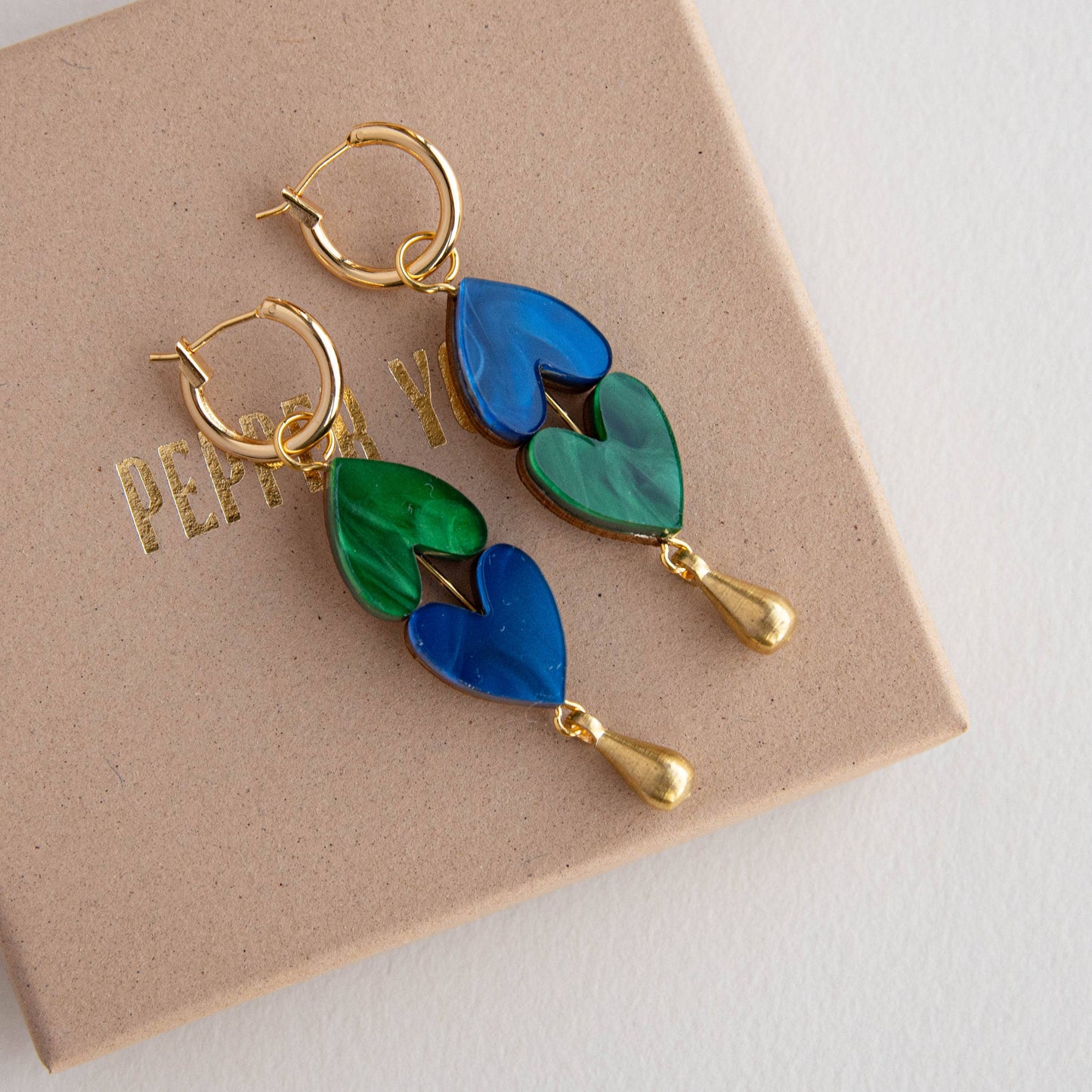 Handmade heart drop earrings on model