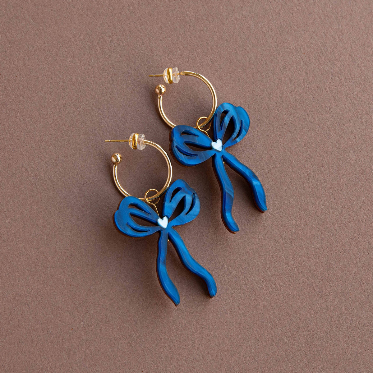 Side profile of handmade bow earrings with hoop fitting