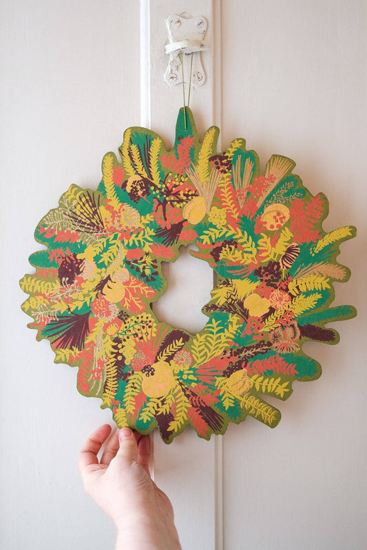 Hand-printed cotton board wreath with winter blooms, sustainable Christmas ornament.