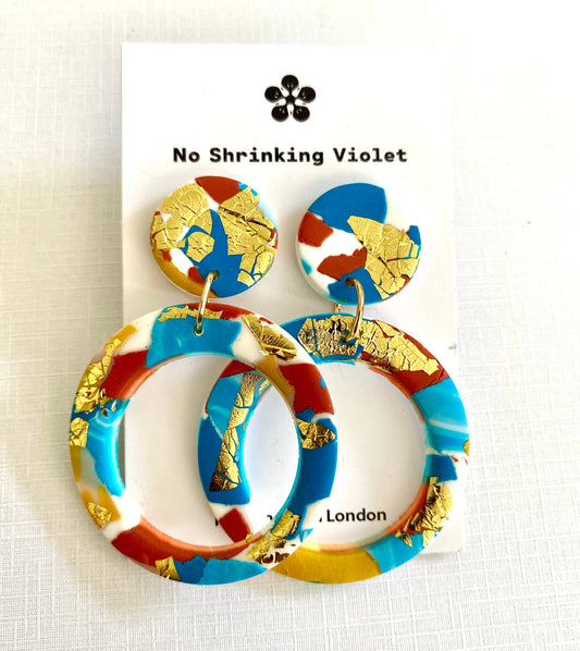Large polymer clay hoop earrings with turquoise, teal, white and terracotta colours, and splashes of gold leaf.