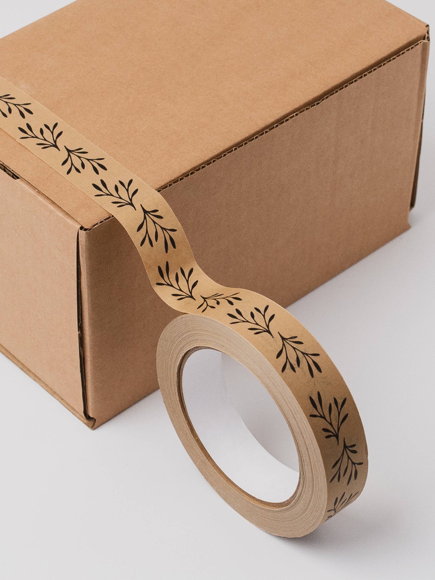 Eco-friendly floral kraft paper tape securely sealing a brown paper parcel