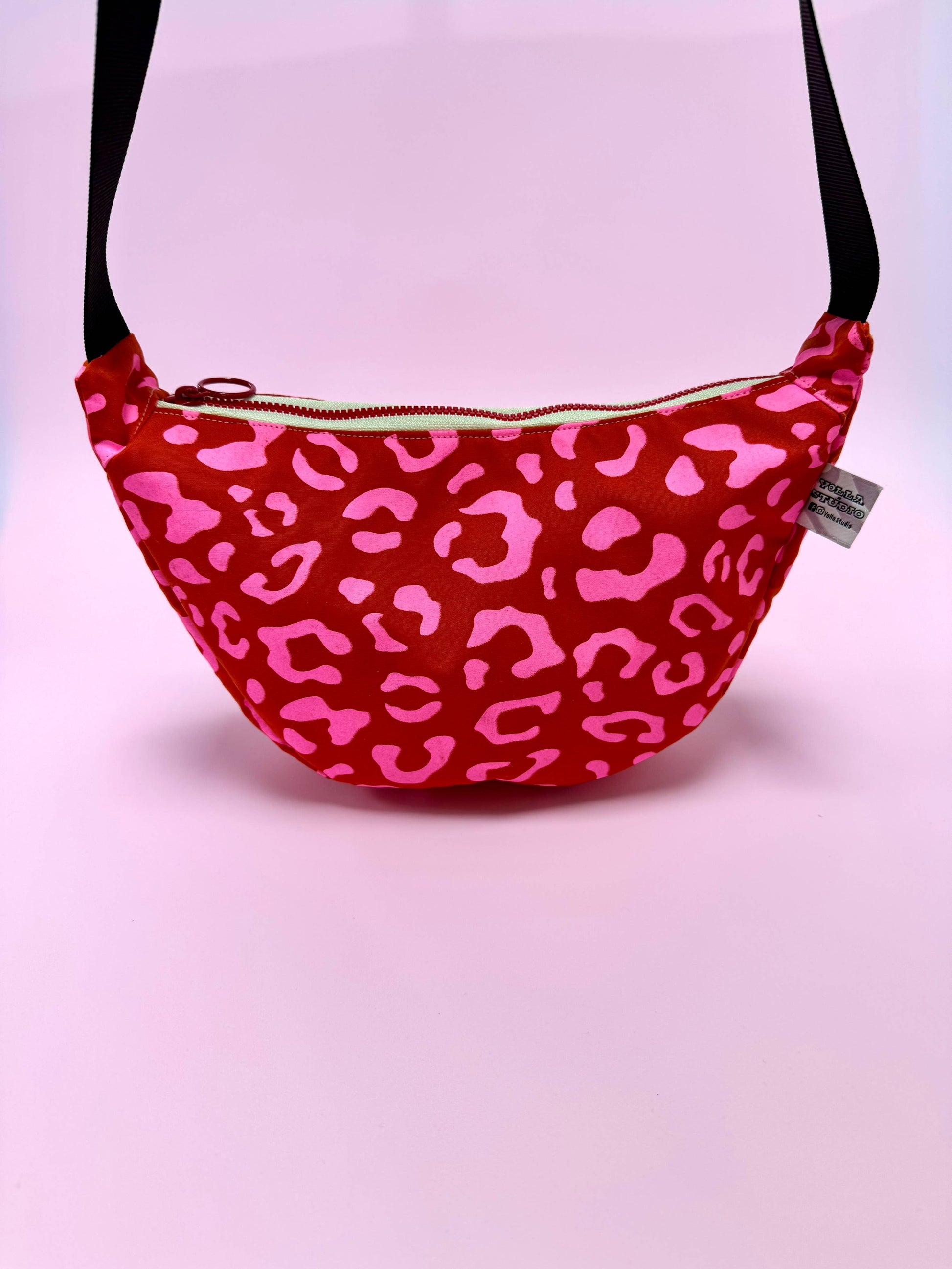 Back view of the red waxed canvas sling bag