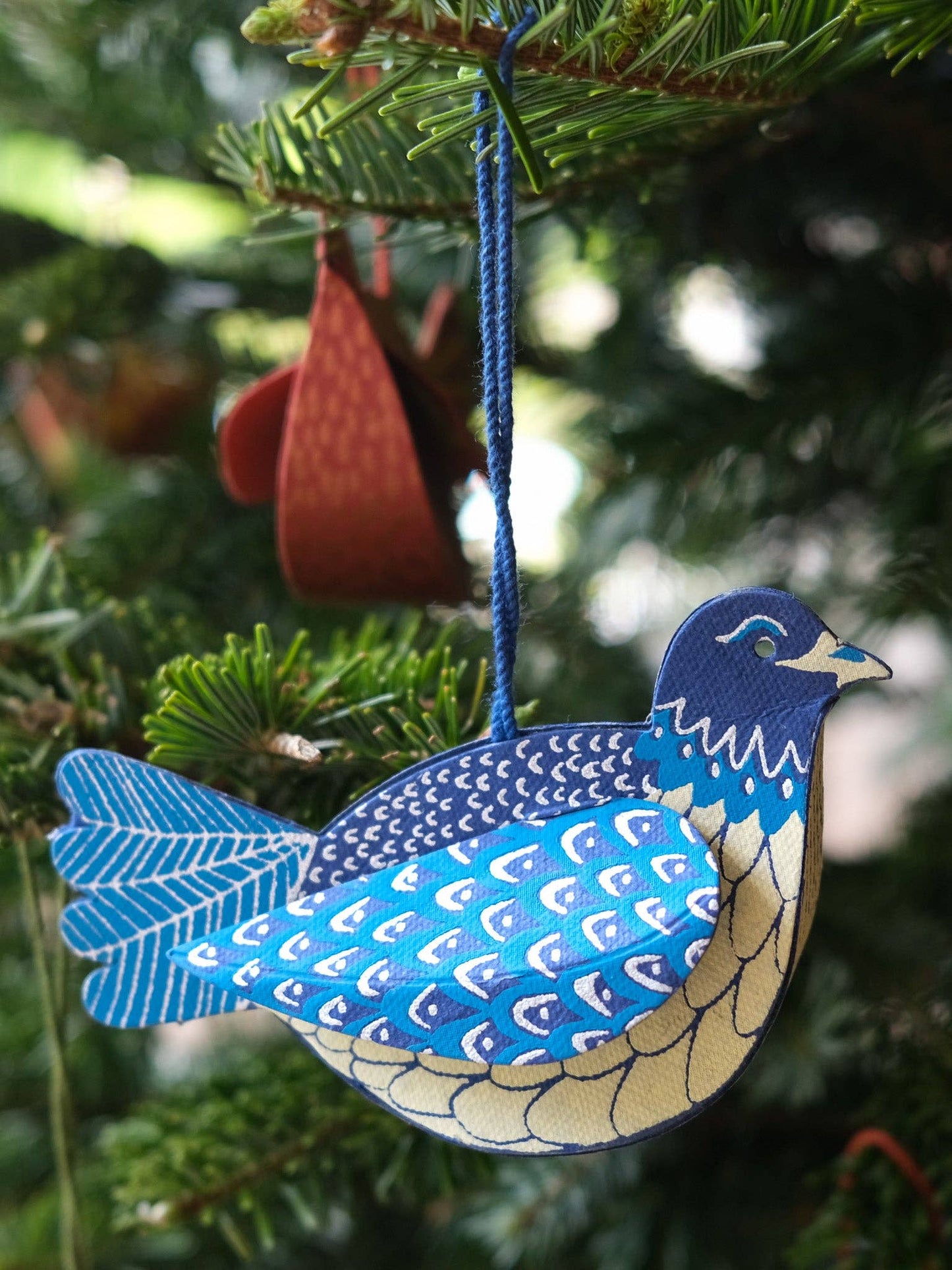 Close-up of screen-printed Dove ornament, eco-friendly design