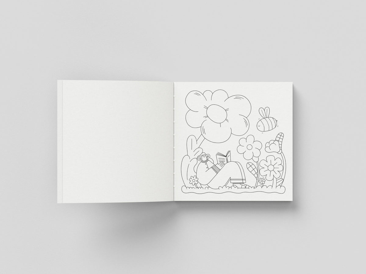 Square format colouring book open on a hand-drawn page