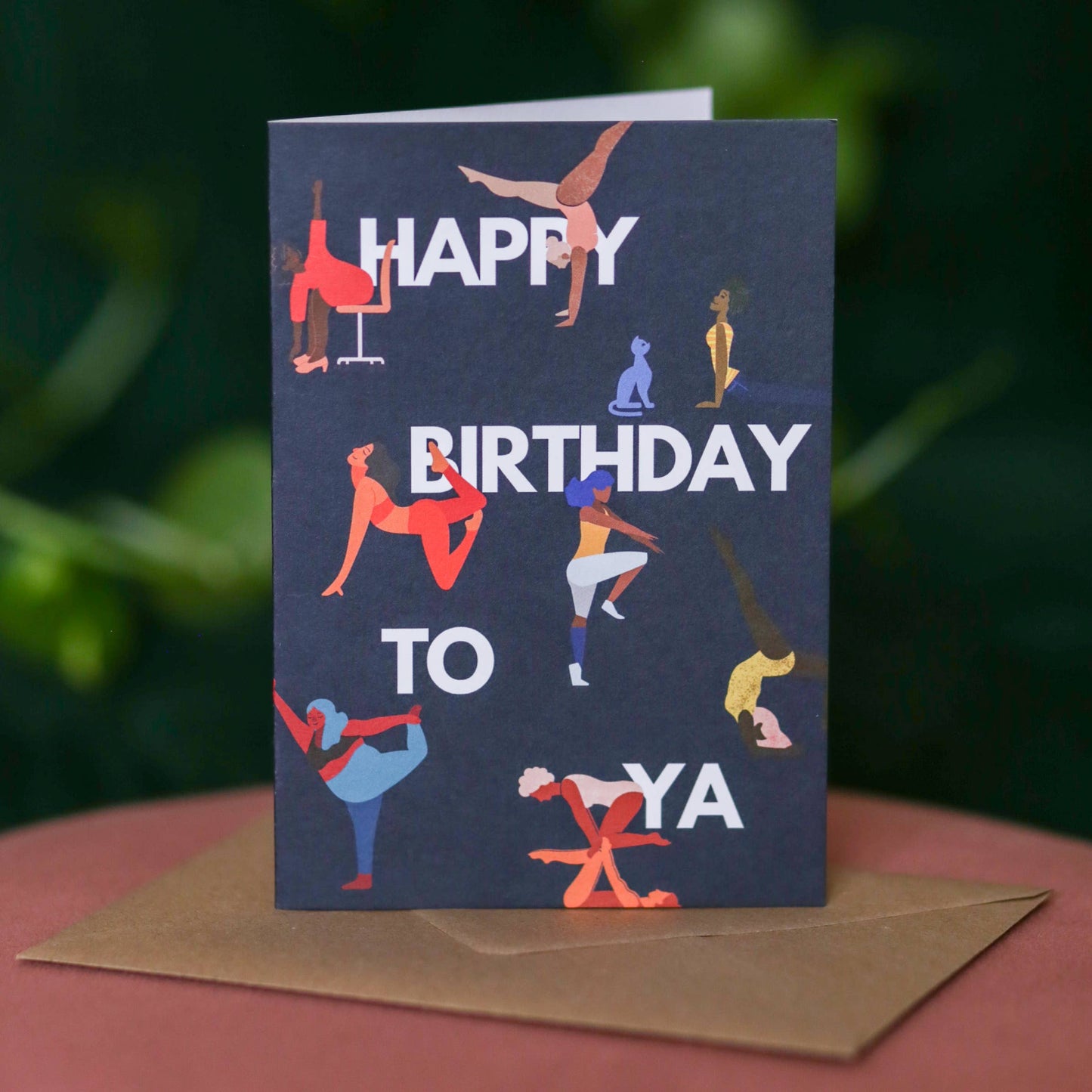 Navy A6 birthday card featuring women doing yoga and gymnastics poses