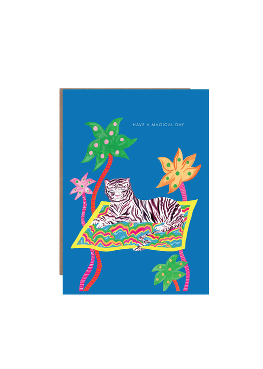Hand-illustrated magical tiger on a magic carpet among palm trees, 5x7” birthday card, recycled kraft envelope, UK made, sustainable and mystical design.