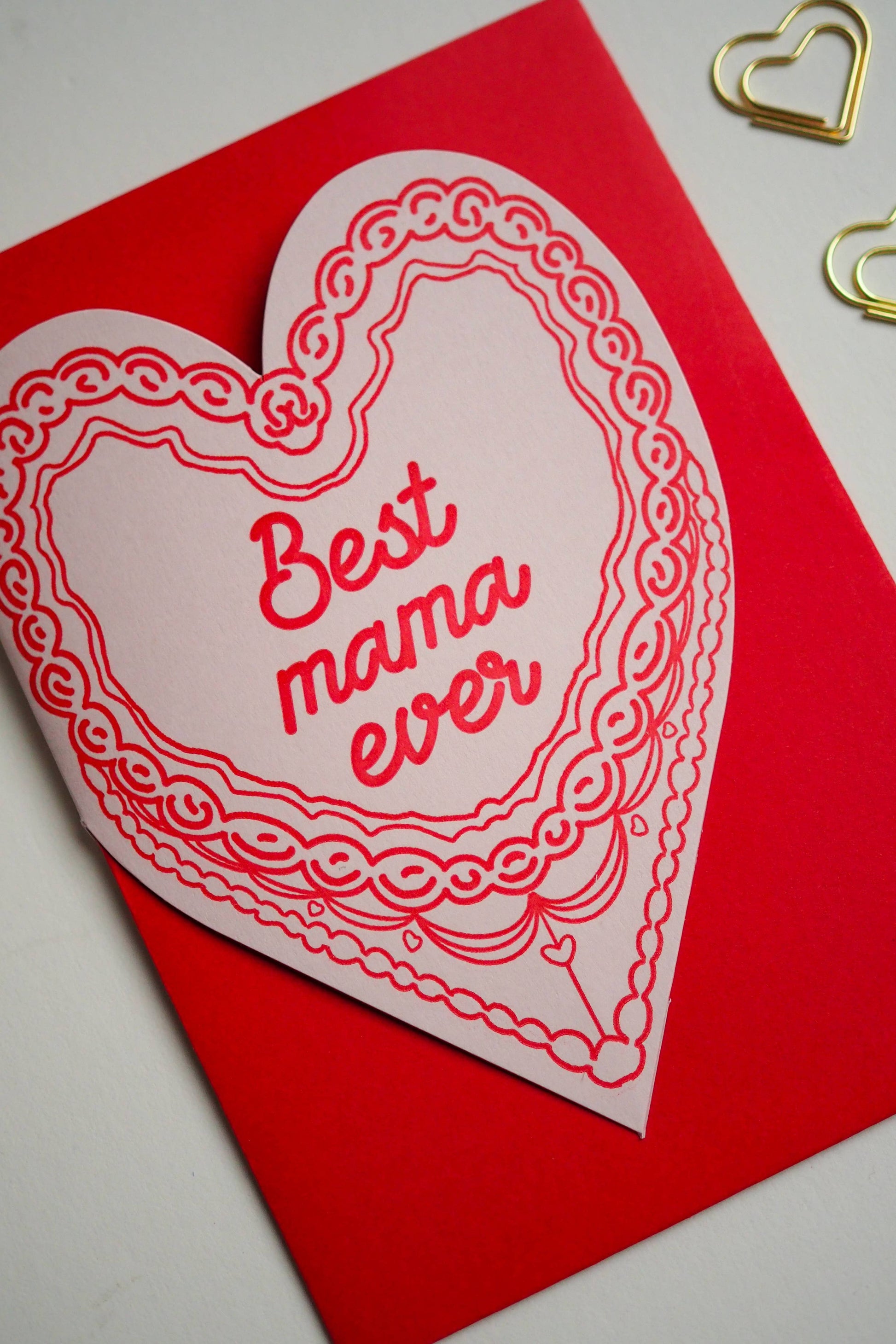 A letter press greeting card featuring a hand drawn retro cake and the words Best Mama ever. Perfect for Mothers Day , new mums &amp; just because. Letter press printed ; die cut on an antique machines.