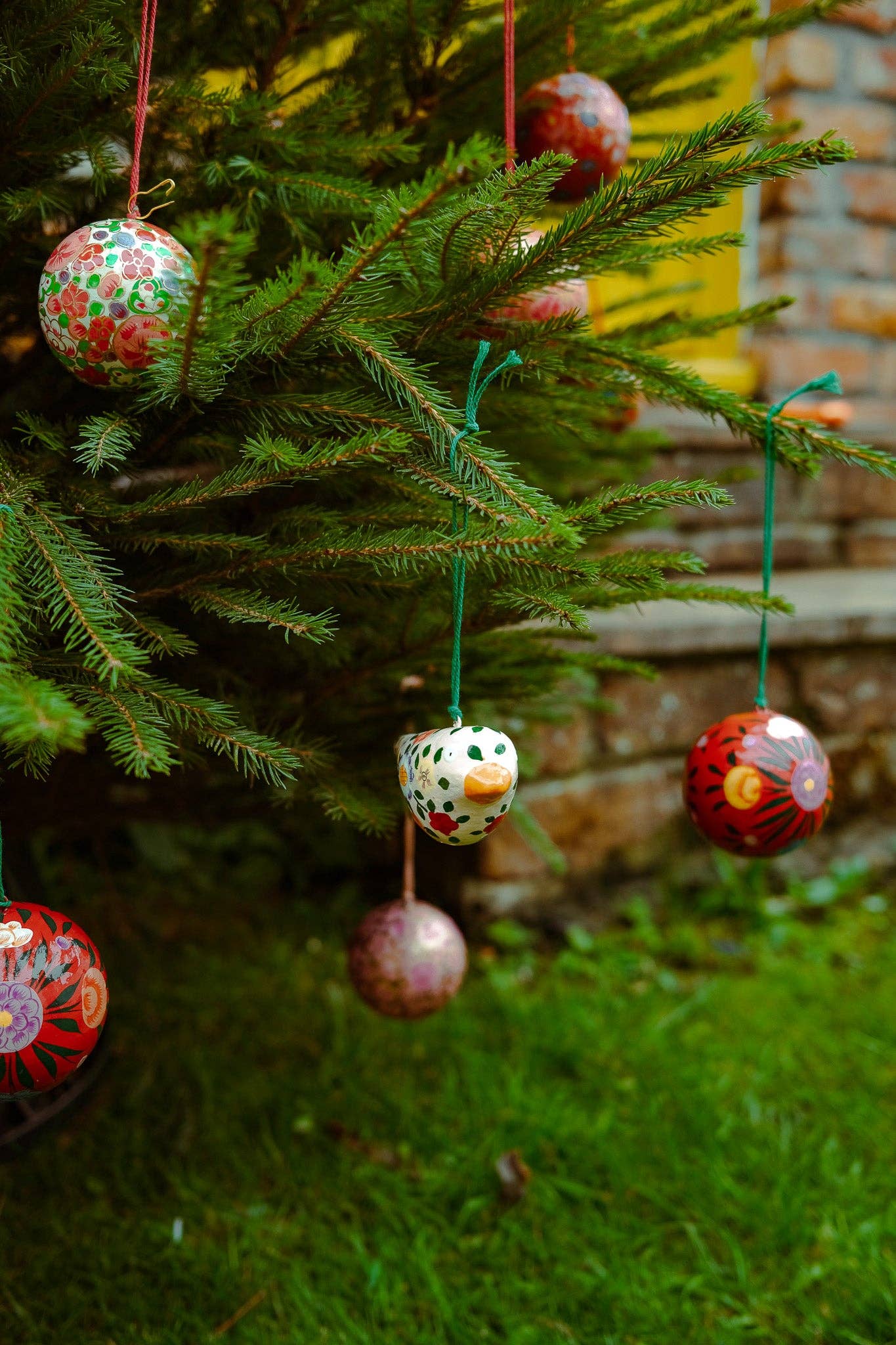 Person holding crimson flower bauble, showing 8cm diameter