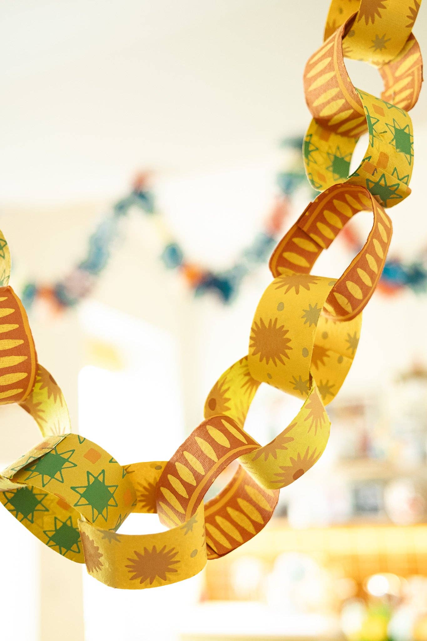 Assembled yellow and green patterned recycled paper chains
