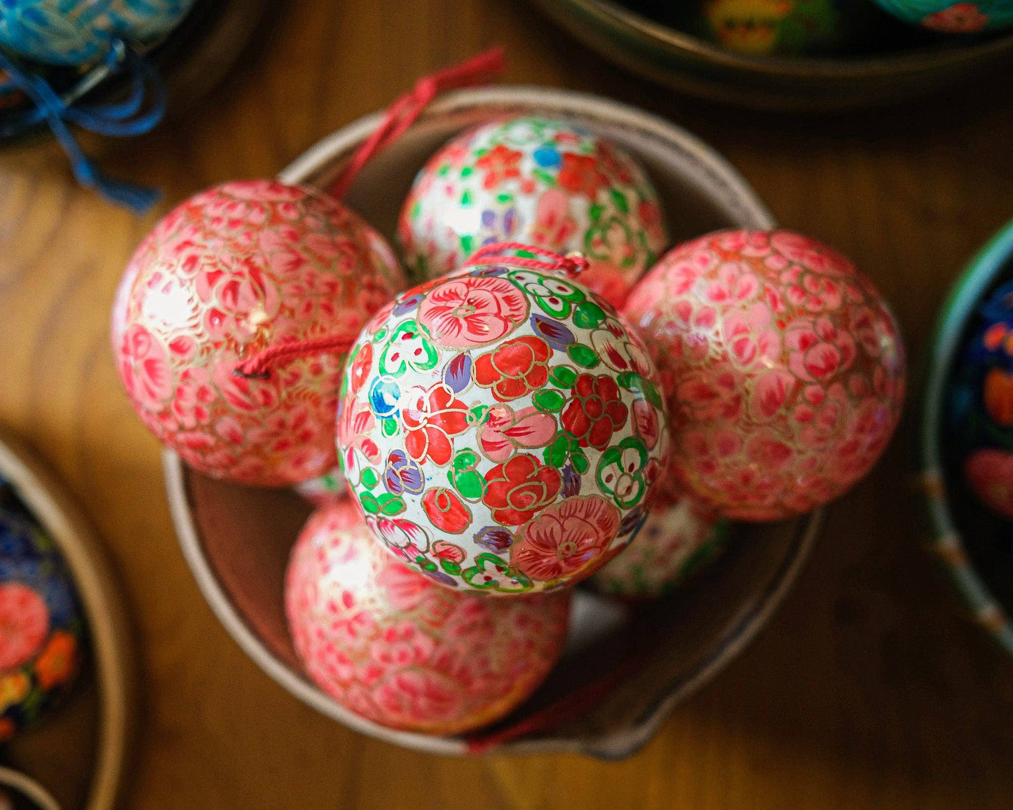 Side view of hand-painted crimson floral bauble