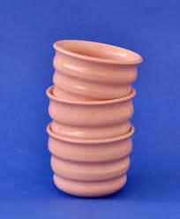 Handcrafted Ripple Beaker in Pink. Handcrafted from stoneware clay, this colourful ceramic beaker with distinctive ripple texture is ideal for your morning coffee, a wine with friends or even a good old cup of water. The quirky rippled form provides a playful aesthetic whilst also being extremely ergonomic to hold, perfect for slotting your fingers comfortably into the grooves. 7 cm high and 9cm wide at the rim.