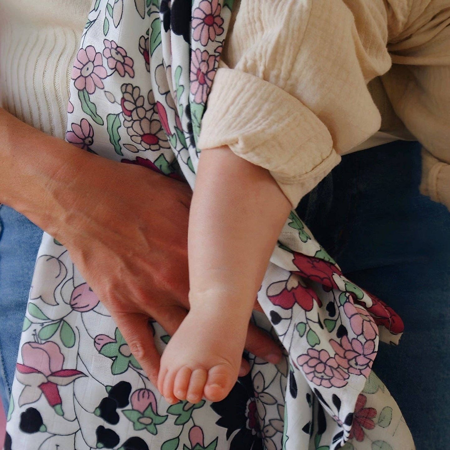 Close‑up of Wharfedale Meadow Liberty print muslin with colourful wildflower pattern for babies aged 5 months and up