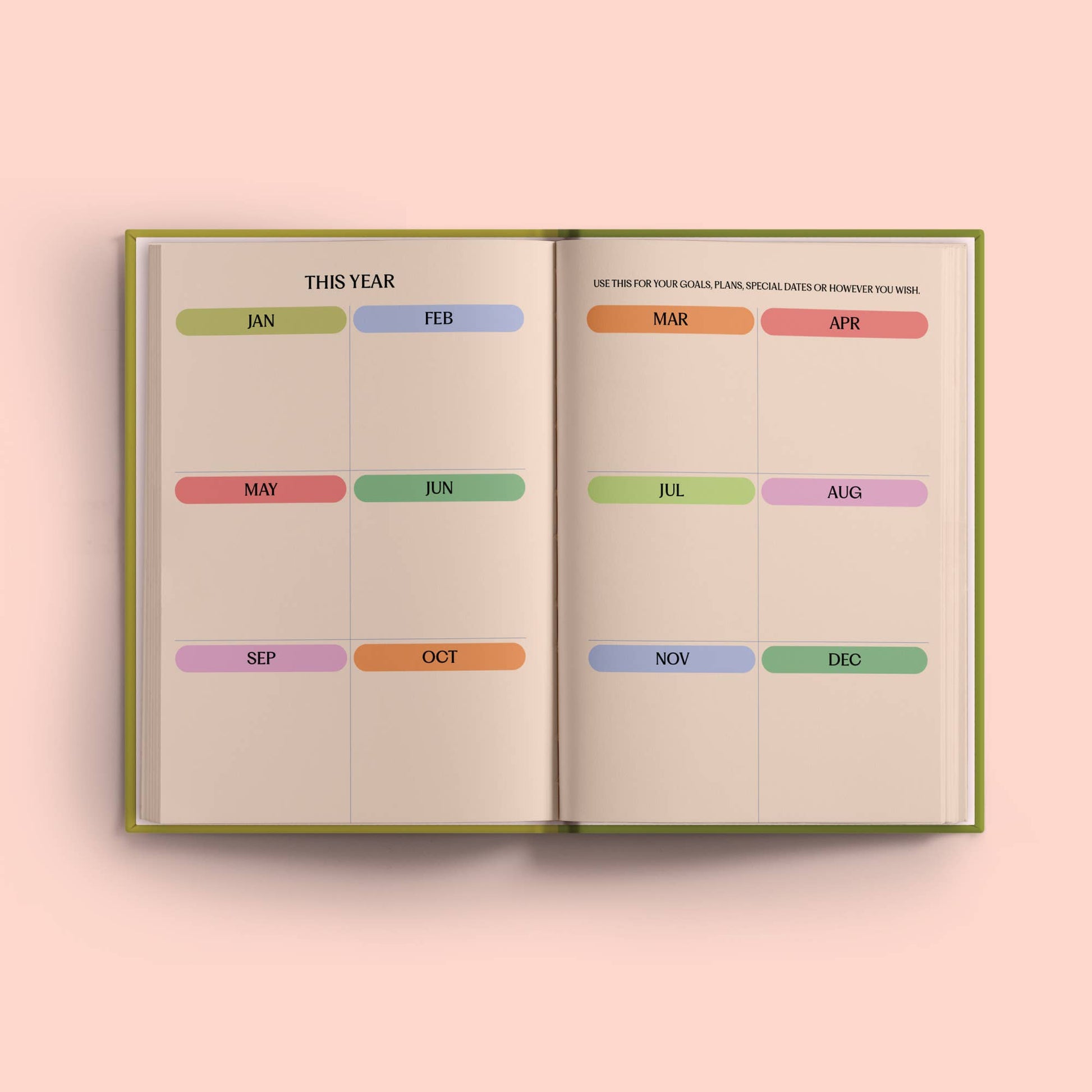 Open diary with monthly tabs on a pink background