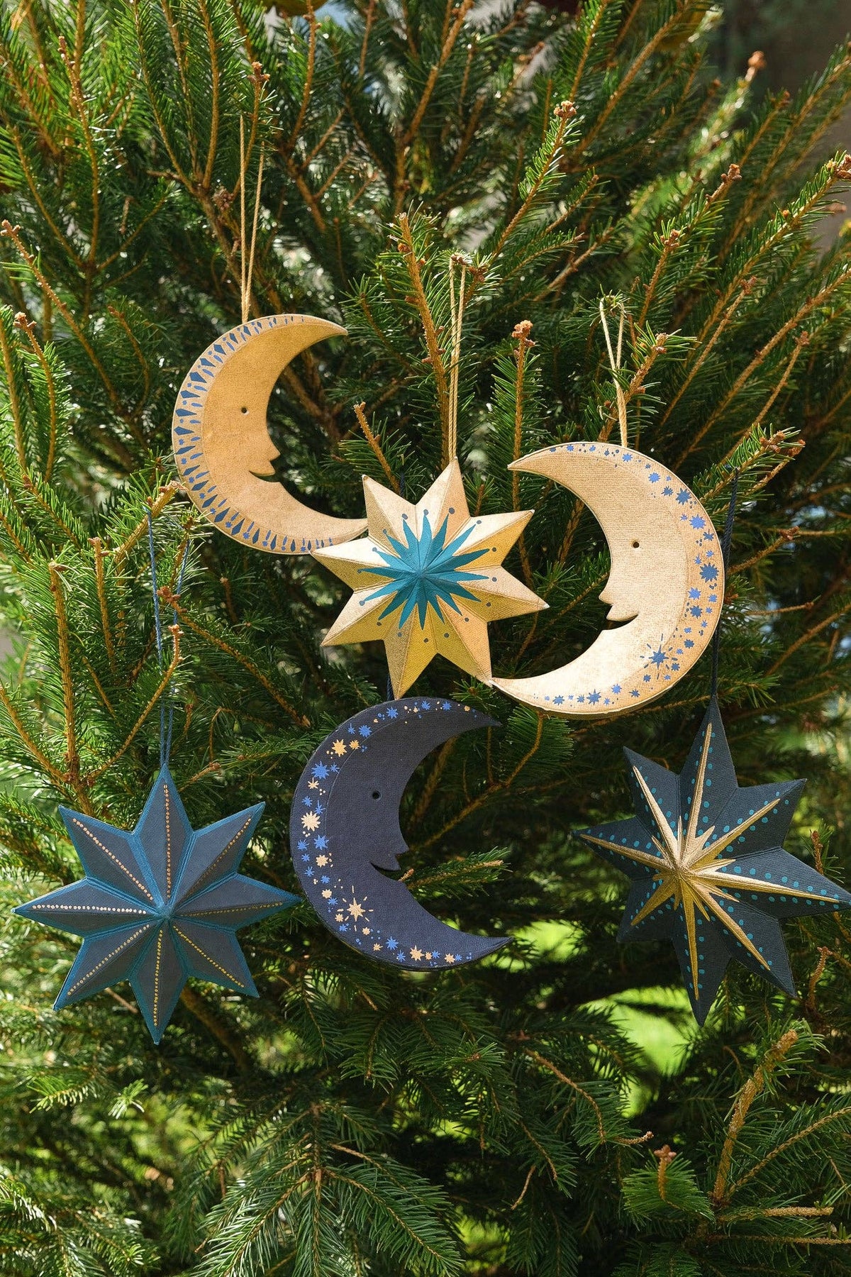 Detailed view of golden Man on the Moon recycled board ornament