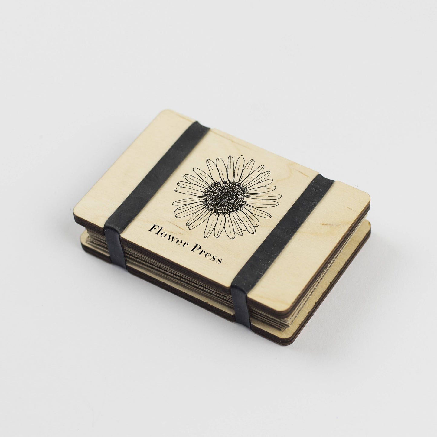 Pocket Flower Press made from sustainable maple veneered wood with corrugated card and sugar paper sheets, silicone rubber bands; pocket-sized and handmade in England.
