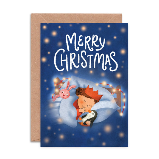 A6 Christmas greeting card with illustration of a sleeping child dreaming of Santa’s arrival, designed by Emily Nash, printed on eco-friendly matte card with kraft envelope.