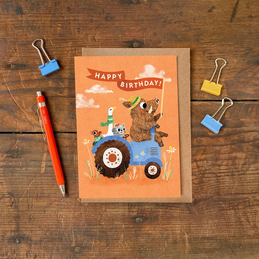 Close up of the sustainably sourced matte card texture and tractor design.