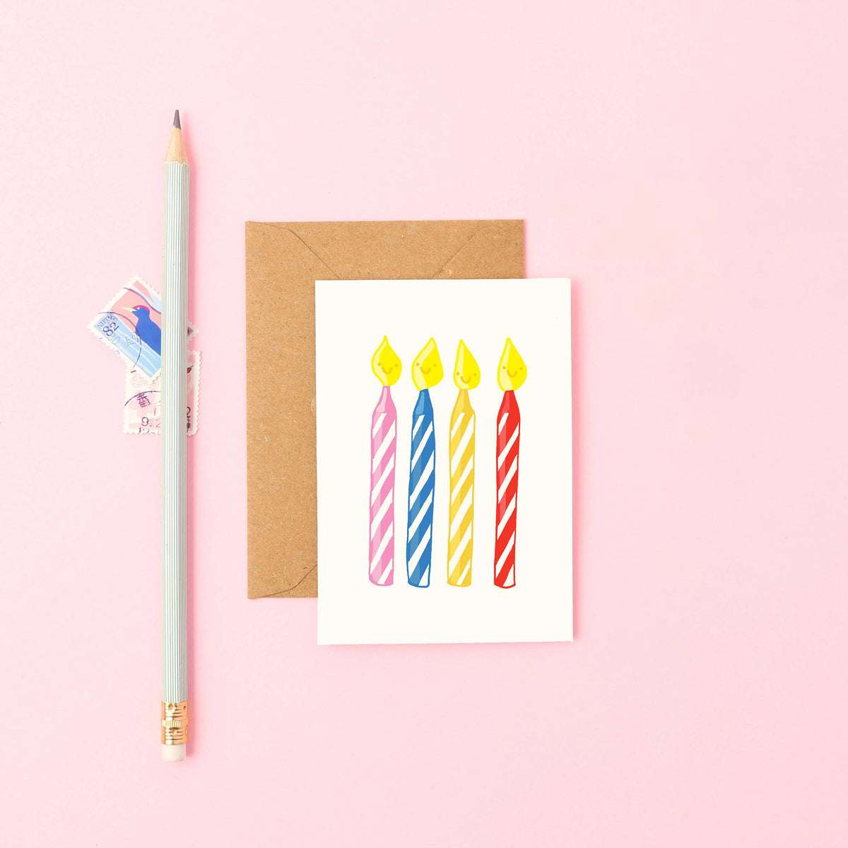 Mini birthday card featuring five colourful hand-drawn candles with smiling faces