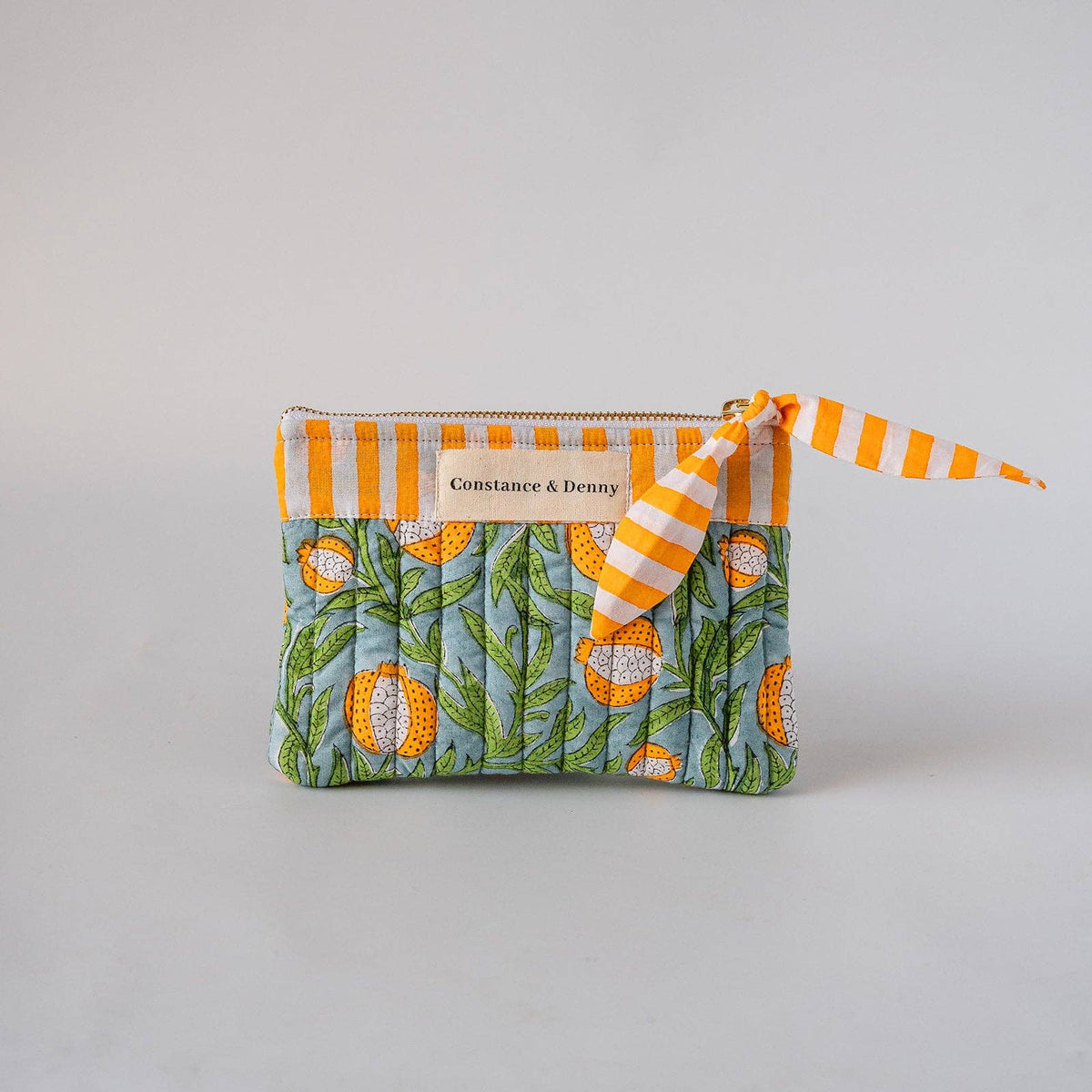 Pomegranate Citron quilted cotton zip pouch showing hand block-printed pattern